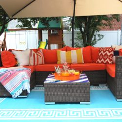 Orange outdoor sectional paired with aqua greek key rug
