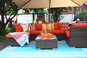 Orange outdoor sectional paired with aqua greek key rug