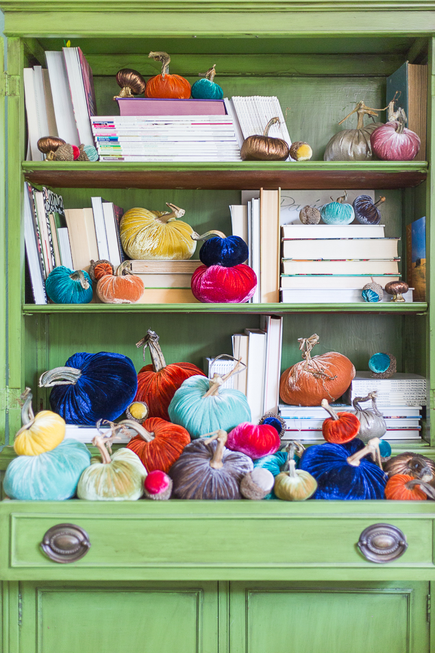 colorful-velvet-pumpkins-styled-in-bookcase